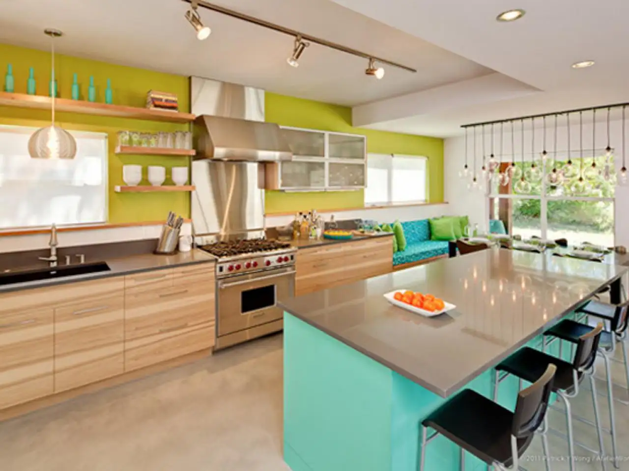 Modern kitchen with island and green accents.